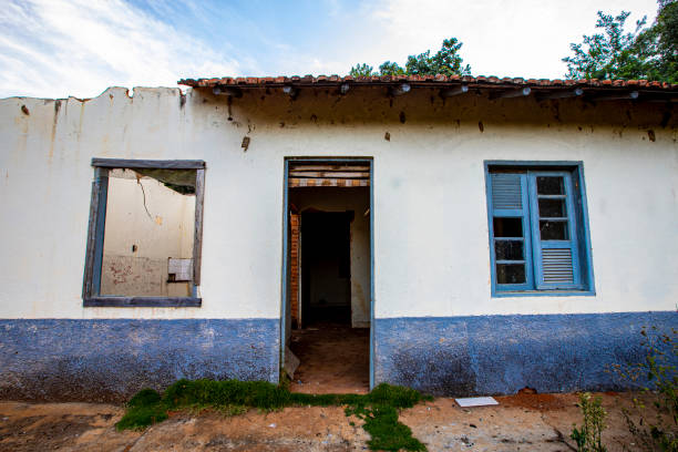 istock Facade of old abandoned house ruined by time 2200482097