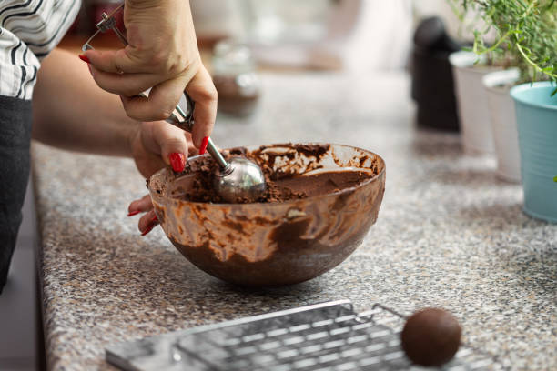 A woman preparing chocolate truffles in the kitchen