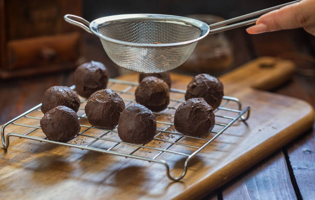 A woman preparing chocolate truffles in the kitchen