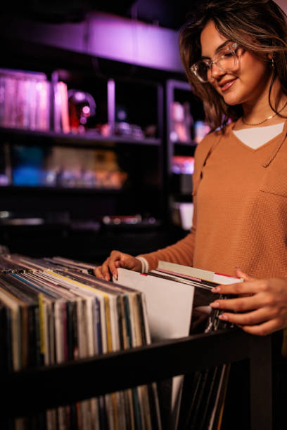 istock Young Woman Selecting Records at Vinyl Store 2200485871