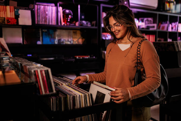 istock Young Woman Contemplating Vinyl Record Purchase 2200485957