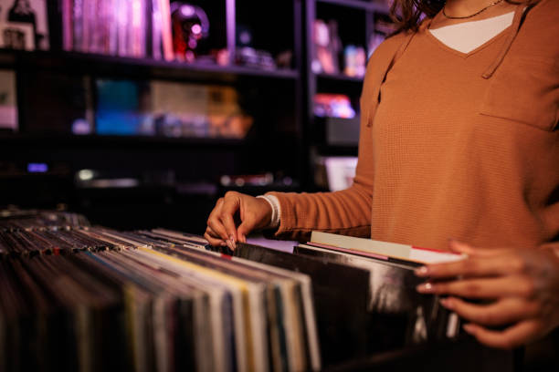istock Young Woman Exploring Vinyl Records in Record Shop 2200486064