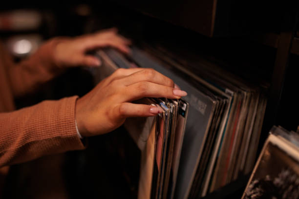istock Young Woman Exploring Vinyl Records in Record Shop 2200486071