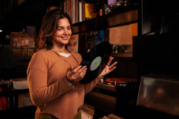 istock Young Woman Holding Vinyl Record Ready to Play 2200486244