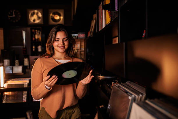 istock Young Woman Holding Vinyl Record Ready to Play 2200486251