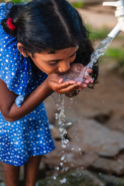istock Sri Lankan young girl drinking a water, Ceylon 2200487430