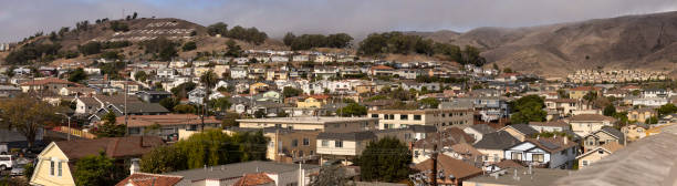 South San Francisco, California, USA - October 27, 2024: The historic South San Francisco hillside sign sits above the city landscape.