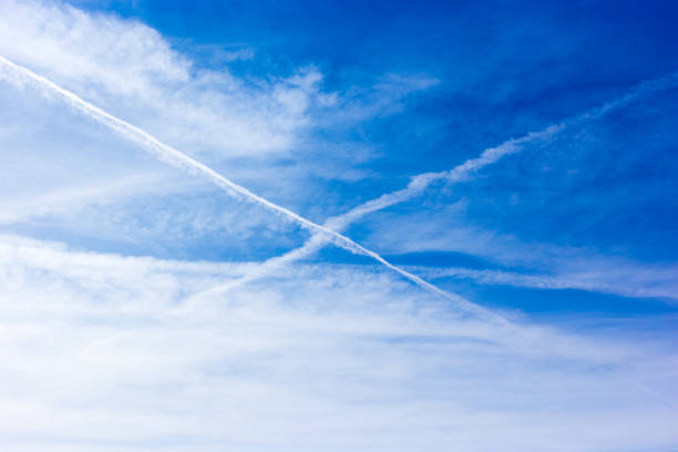 istock Blue Sky with White Contrails Criss-Crossing 2200489815
