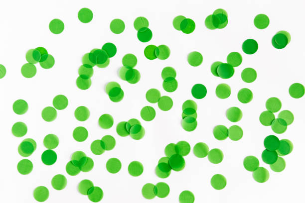 istock Festive background. Green confetti on a white background, flat lay. 2200489966