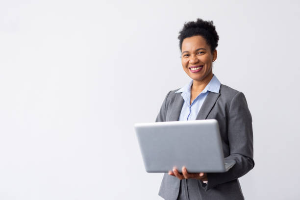 istock Smart African American professional checking emails on a laptop while standing 2200490106