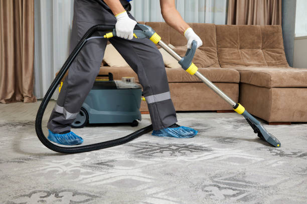 istock Professional cleaning company worker using vacuum cleaner in spacious living room 2200490356