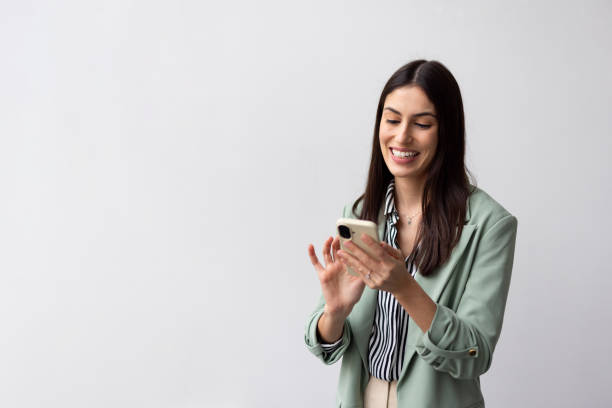 istock Successful Latina entrepreneur browsing on a smartphone 2200491204