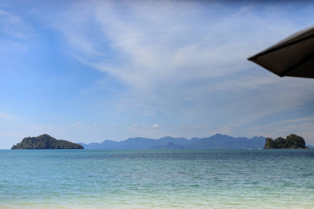 Beachside chair and table with beach and sea background. Relaxation beach view. Lifestyle resort. Depth of field concept.