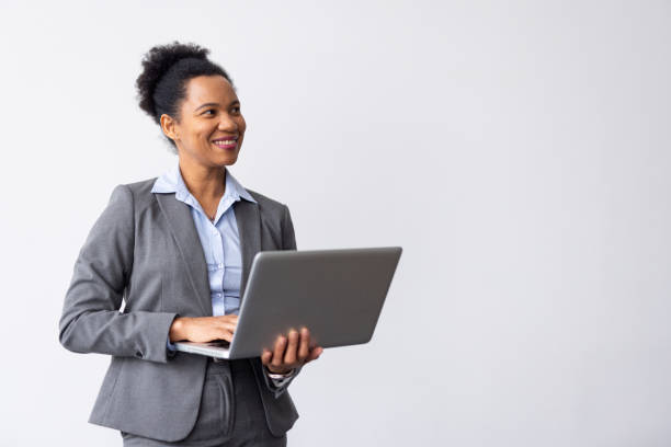 istock Modern African American professional typing on a laptop while carrying it 2200494252