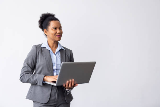 istock Stylish African American professional analyzing data on a laptop in her hands 2200494275