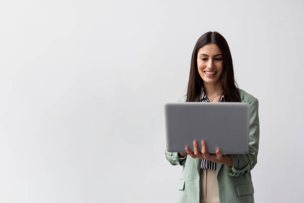 istock Successful Latina entrepreneur analyzing data on a laptop she is holding 2200494906