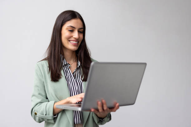 istock Professional Latina woman balancing a laptop in her hands while working 2200495810