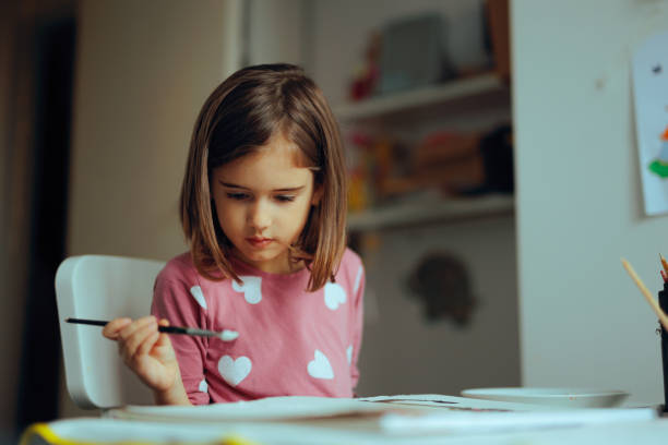 istock Girl Enjoying Painting as a Fun Home Artistic Activity 2200497665