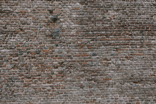 An old brick wall with a basketball hoop in Neuss, North Rhine-Westphalia, Germany