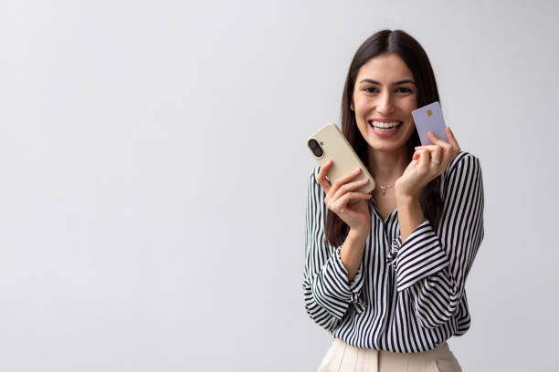 istock Excited Latina shopper making a secure payment on her smartphone 2200500954