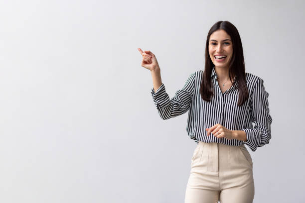 istock Happy Latina woman pointing with her finger 2200501921