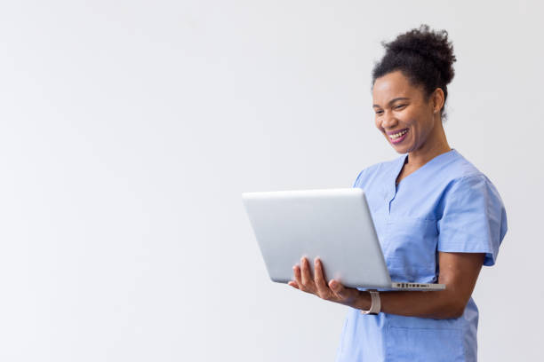 istock Professional nurse typing on a handheld laptop 2200501991