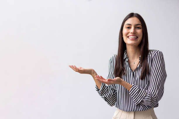istock Joyful Latina woman pointing upwards with enthusiasm 2200502464