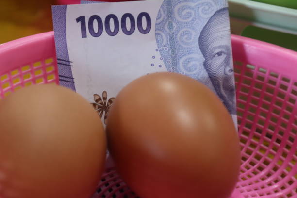 istock boiled eggs and cash, egg price illustration. 2200502836