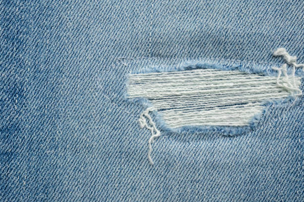 istock Denim blue jeans torn fashion design texture close up background 2200505448