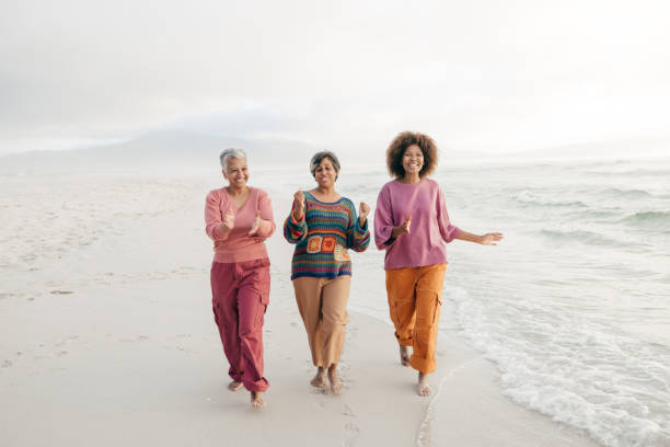 istock Women on the move: friendship and laughter by the ocean 2200505949