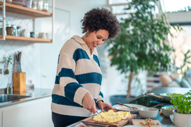 istock Joyful Mixed Race Woman Creating Butter Board 2200507040