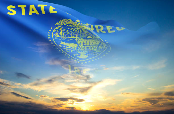 Flag of Oregon US state against the sunset
