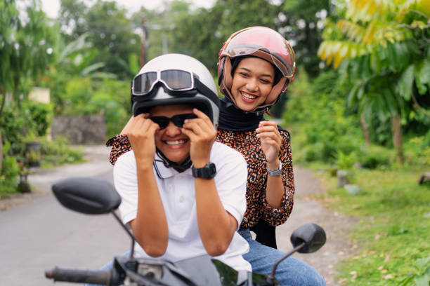 istock Happy Young Couple Laughing on Sitting Motorcycle 2200507846
