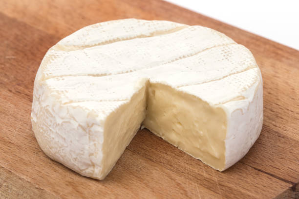 Creamy Brie on rustic wooden background, top view