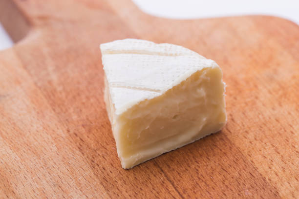 Creamy Brie on rustic wooden background, top view
