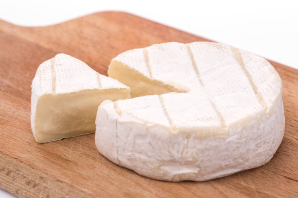 Creamy Brie on rustic wooden background, top view