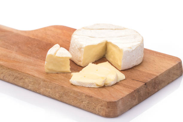 Creamy Brie on rustic wooden background, top view