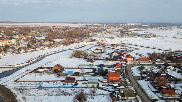 istock Snowy town with houses and a river 2200515496