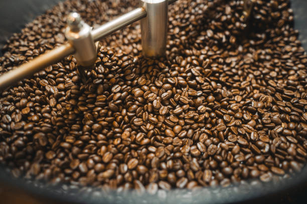 istock Brown roasted coffee beans in machine, coffee beans background 2200517083