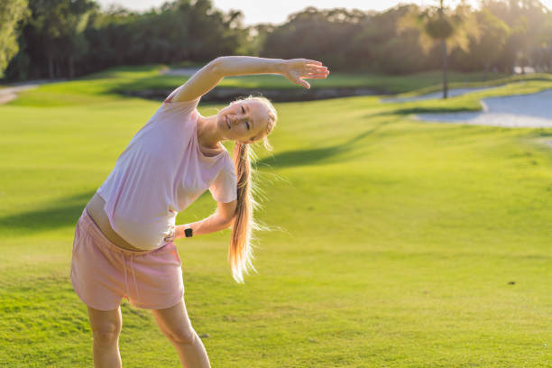 istock Energetic pregnant woman takes her workout outdoors, using an exercise mat for a refreshing and health-conscious outdoor exercise session 2200519651