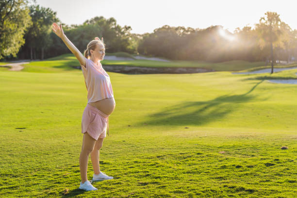 istock Energetic pregnant woman takes her workout outdoors, using an exercise mat for a refreshing and health-conscious outdoor exercise session 2200519661