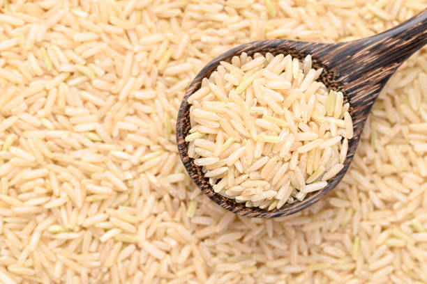 istock Organic Jasmine brown rice seed in wooden spoon, Thai Rice 2200521294