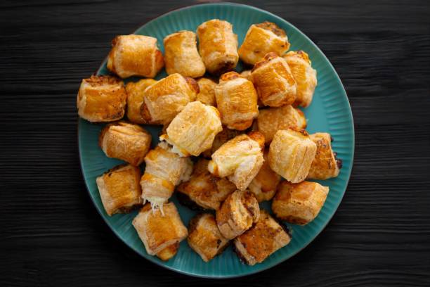 istock Golden-brown puff pastries on a teal plate. 2200522786