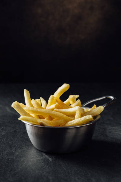 istock French fries on black background 2200522810