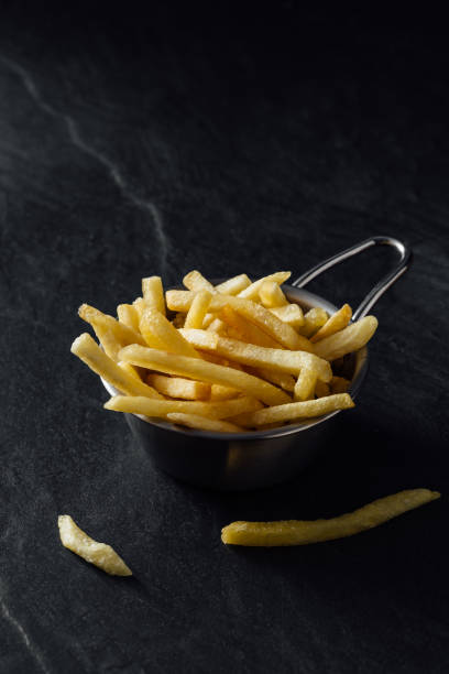 istock French fries on black background 2200522827
