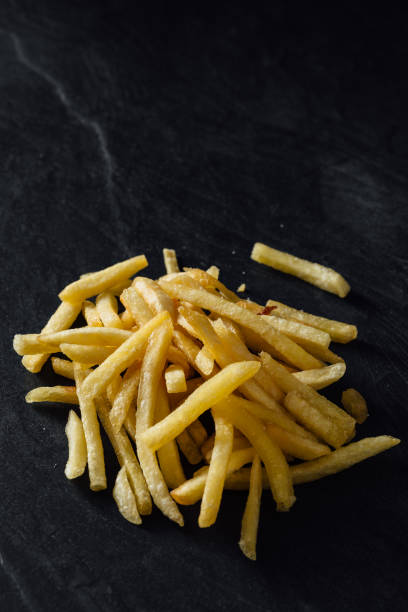 istock French fries on black background 2200522853
