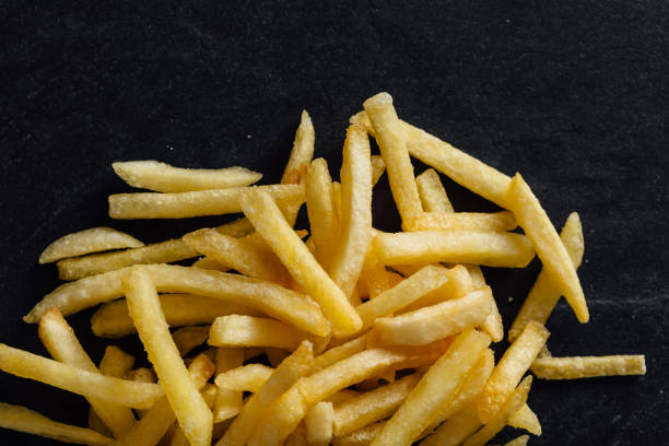 istock French fries on black background 2200522856