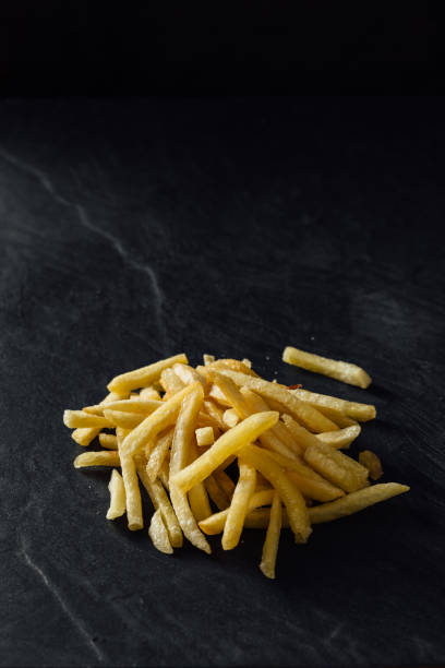 istock French fries on black background 2200522859
