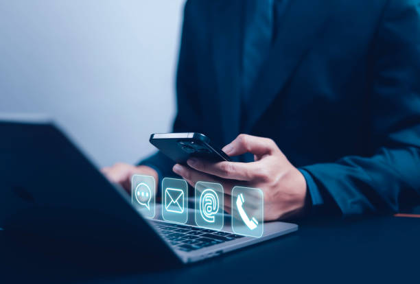 istock Businessman using phone to contact customer support, showing contact icons (address, phone, email, mobile, call). 2200522918