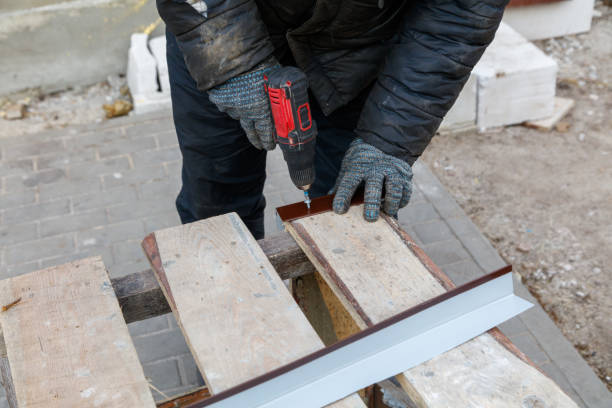 istock A man is using a drill to make a hole in a wooden plank 2200525308